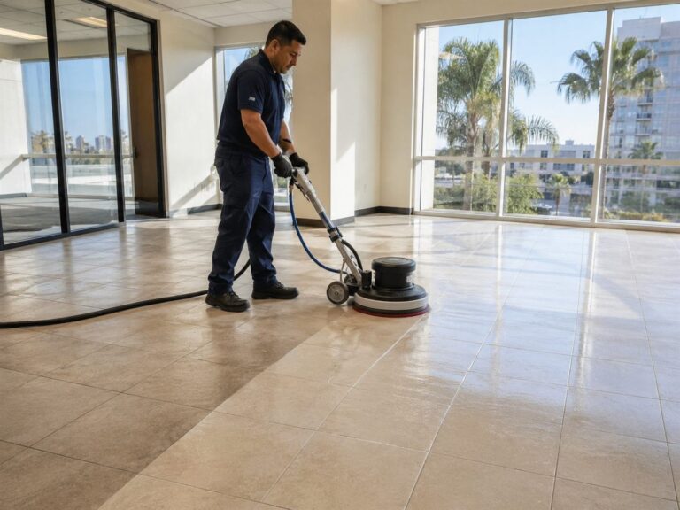 Technician running a floor machine across tile in a San Diego office suite